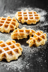 Belgian waffles sprinkled with sugar.