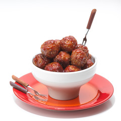 meatballs in a bowl with cocktail forks
