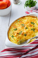 Sliced vegetables: onions, zucchini with olive oil. Seasoned with black pepper. Ready for the oven.