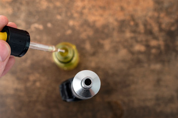 Close up off e cigarette and liquid bottle. Top view.