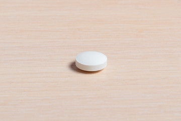 Slide of white tablets on a light table.