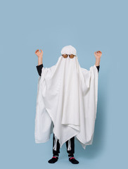Baby ghost in glasses, shot isolated on a blue