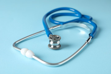 Stethoscope on blue background, close up. Healthcare