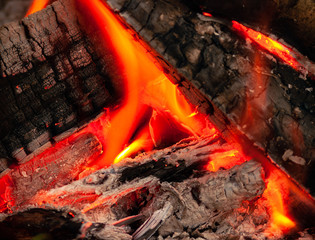 firewood burning in fireplace at night
