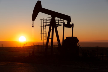 View of Oil Well Pumpjack (Horsehead) at Sunset Oil Industry