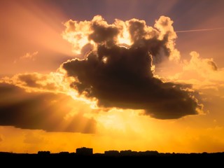 Dramatic Cloudscape with isolated sunrays around cloud