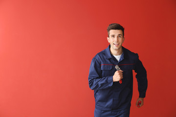 Running car mechanic on color background