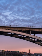 A couple on their evening walk over Västerbron in Stockholm, Sweden