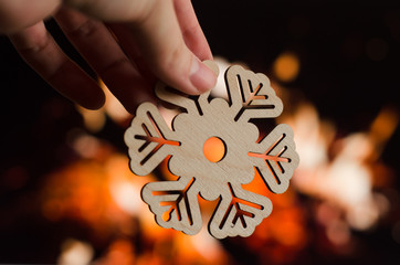 Wooden snowflake christmas decoration on fireplace background