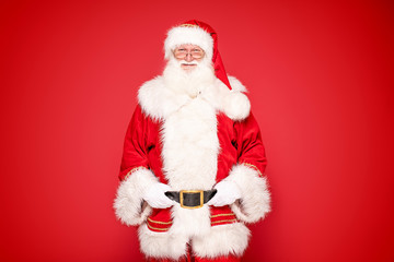 Real Santa Claus on red studio background.