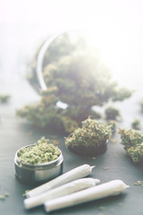 weed Joint Macro of cannabis buds marijuana with trichomes and crushed weed on a black table insta...