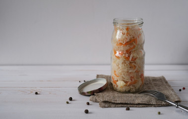 Pickled cabbage with carrot in glass jar. Homemade preserving. Russian traditional food
