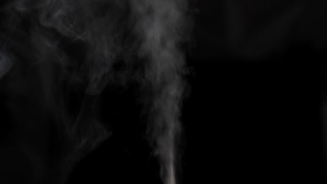 Steam rising on black background. Nobody
