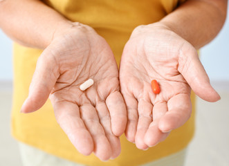 Elderly woman with pills, closeup