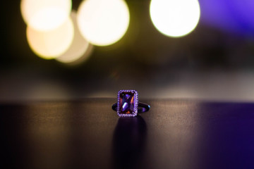 Silver ring with big stone on a table
