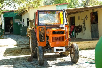 Obraz premium Old orange rusty farm tractor.