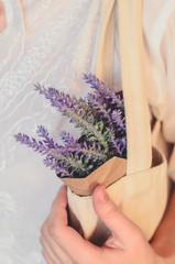 Close-up textile bag and a bunch of lavender in paper as a concept of biodegradable package