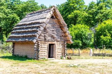 Fototapeta na wymiar Small shepherd hut with straw roof on sunny day