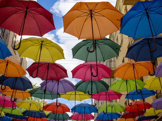 Fototapeta na wymiar Colorful umbrellas hanging on top side