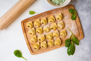 Tortelloni - italian pasta stuffed with ricotta and spinach. Raw, homemade.