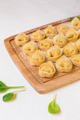 Tortelloni - italian pasta stuffed with ricotta and spinach. Raw, homemade.