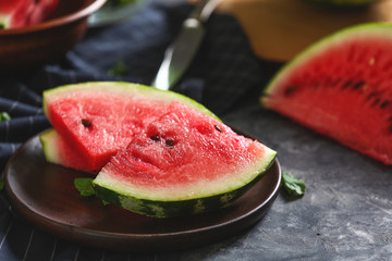 Plate with tasty watermelon on dark table