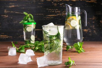 Glass of healthy infused water with ice cubes on table