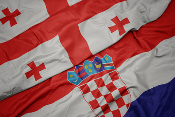 Fototapeta premium waving colorful flag of croatia and national flag of georgia.