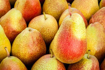 Ripe red pears lie on the counter of the village market