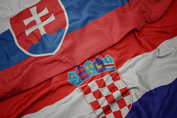waving colorful flag of croatia and national flag of slovakia. © luzitanija