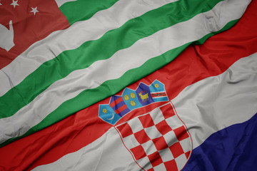 waving colorful flag of croatia and national flag of abkhazia.