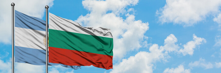 Obraz premium Argentina and Bulgaria flag waving in the wind against white cloudy blue sky together. Diplomacy concept, international relations.