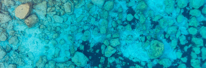 Fototapeta na wymiar An aerial view of the beautiful Mediterranean sea, where you can se the rocky textured underwater corals and the clean turquoise water of blue lagoon Agia Napa