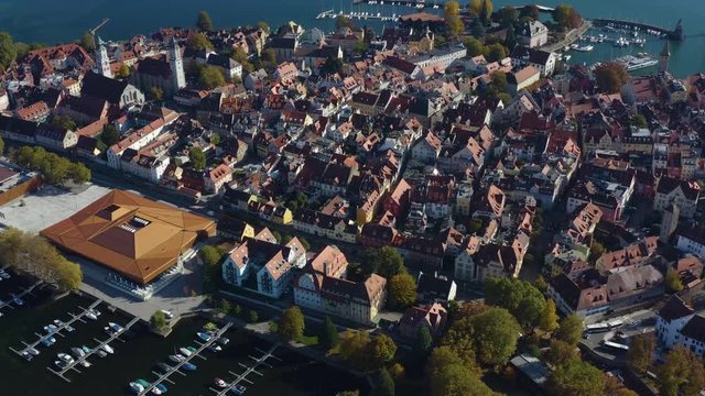 Aerial view of the city and island Lindau on lake Constance in Germany on a sunny day in autumn. Zoom in from the back of the island.