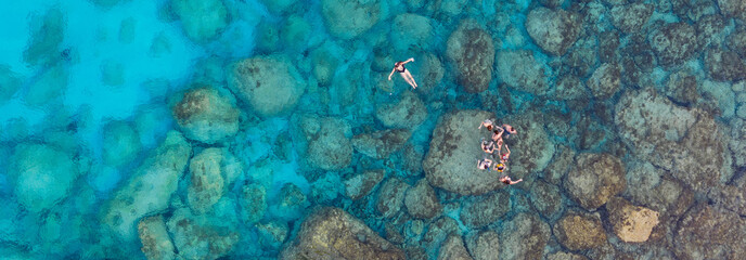 An aerial view of the beautiful Mediterranean sea, where you can se the rocky textured underwater corals and the clean turquoise water of blue lagoon Agia Napa