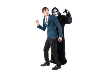 Man in a Halloween grim reaper ghost costume chasing, mocking and making fun of scared businessman...