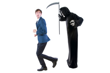 Man in a Halloween grim reaper ghost costume chasing, mocking and making fun of scared businessman...
