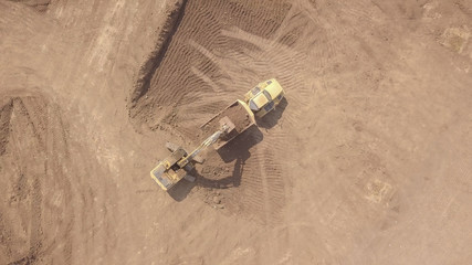 Performing earthworks on a new construction site for residential construction. Aerial view.