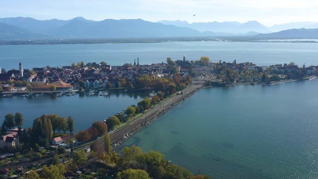 Aerial view of the city and island Lindau on lake Constance in Germany on a sunny day in autumn. Far descend beside the island.