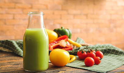 Bottle of fresh vegetable juice on table