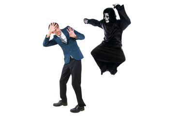 Man in a Halloween grim reaper ghost costume chasing, mocking and making fun of scared businessman...