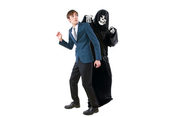 Man in a Halloween grim reaper ghost costume chasing, mocking and making fun of scared businessman...