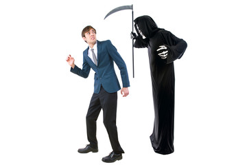 Man in a Halloween grim reaper ghost costume chasing, mocking and making fun of scared businessman...