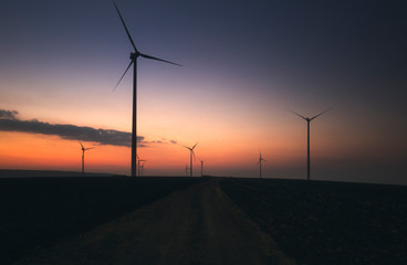 wind turbines at sunset