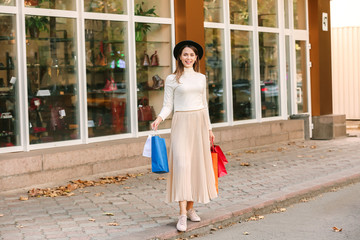 Fototapeta premium Beautiful young woman with shopping bags outdoors