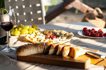 Italian food with glass of red wine served on the summer table outdoor