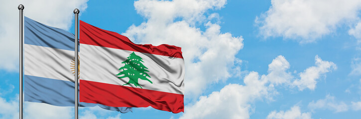 Argentina and Lebanon flag waving in the wind against white cloudy blue sky together. Diplomacy concept, international relations.