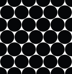 Seamless polka dot pattern in triangular arrangement. Black dots on white background. Vector illustration © pyty