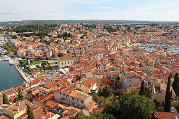 Naklejka na ściany i meble View from the bell tower of the Church of St. Euphemia on the tiled rooftops of the romantic and colorful town of Rovinj, Croatia, located in the north of the Adriatic Sea. Europe.
