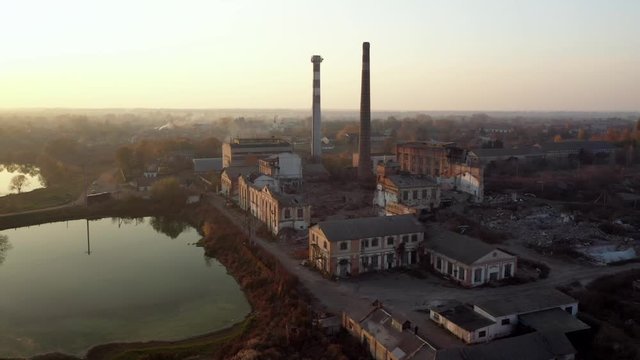 Aerial view of an old factory ruin and broken windows. Old industrial building.